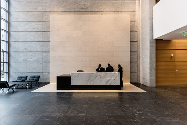 Elegant View Of The Lobby At Rugo Stone's 600 Massachusetts Project, Showcasing Intricate Stonework And Architectural Design.