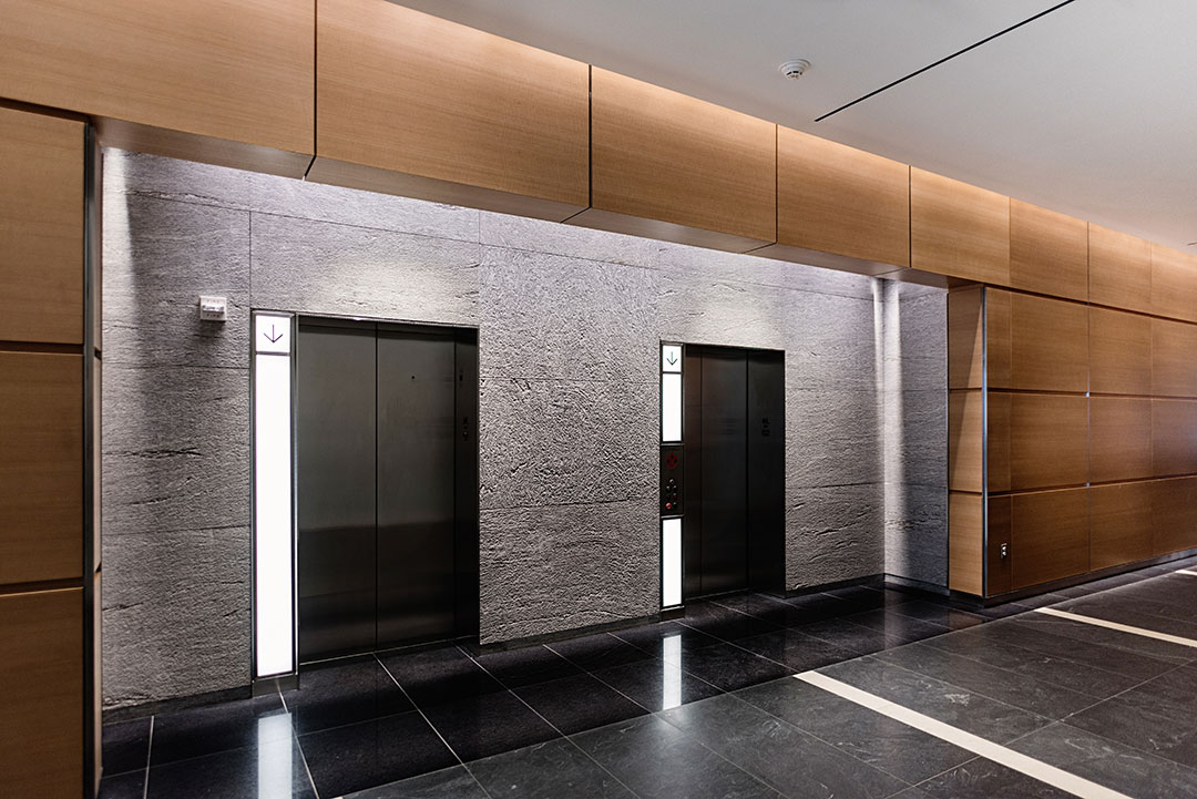 Another view of the lobby at Rugo Stone's 600 Massachusetts project, emphasizing the sophisticated stone craftsmanship and architectural details.