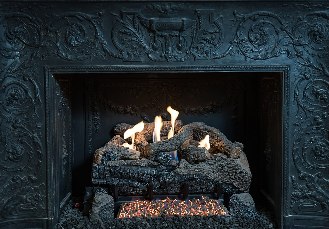 Exquisite stonework in the Cosmos Club fireplace, showcasing intricate detailing and exceptional craftsmanship.