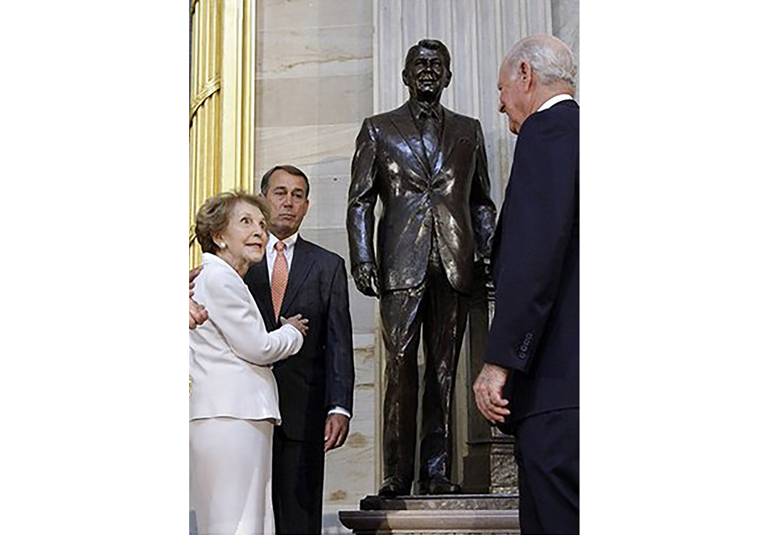 Base of the Ronald Reagan statue at the U.S. Capitol, featuring detailed stone carvings and artistic craftsmanship.