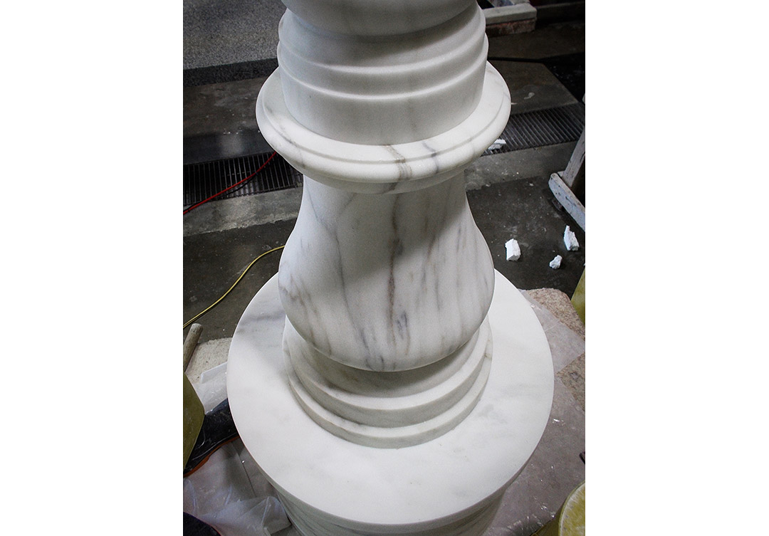 Detailed stone water fountain at the Trone Residence, highlighting fine craftsmanship and elegant design.