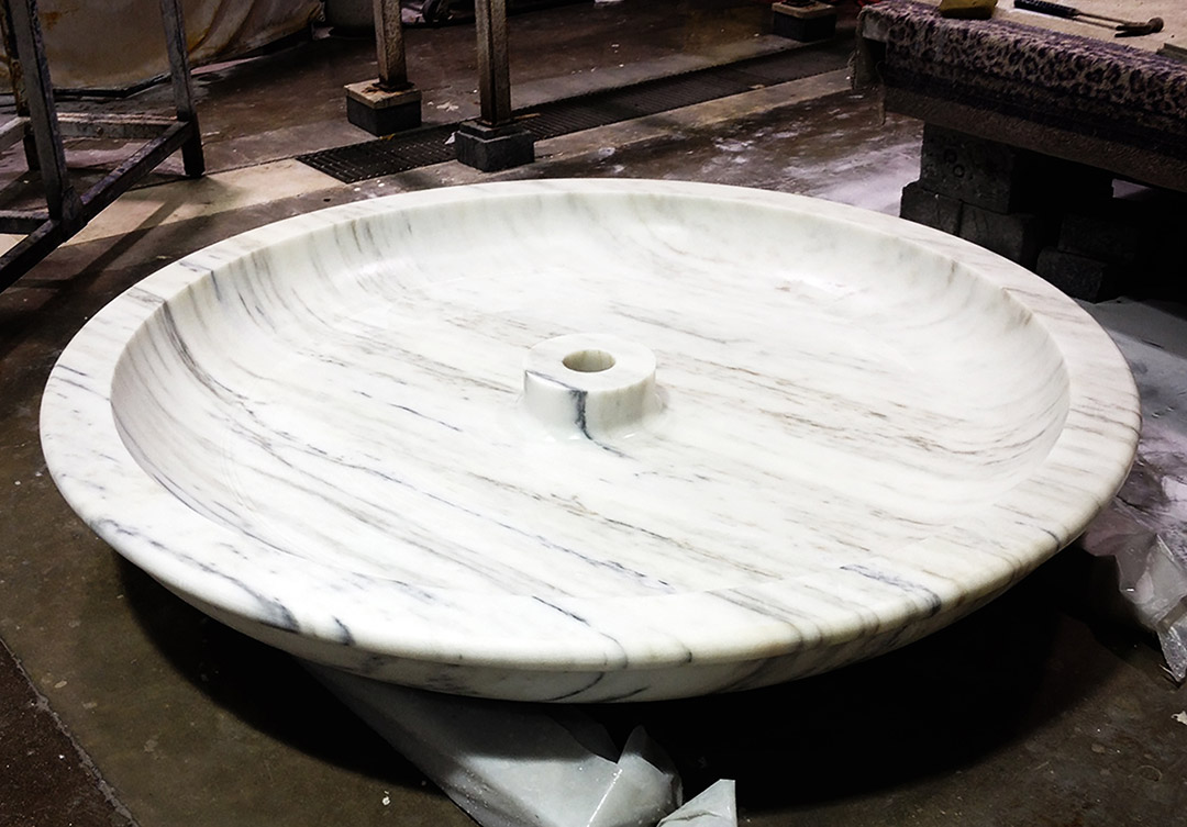 Sophisticated stone water fountain at the Trone Residence, featuring intricate carvings and exceptional craftsmanship.