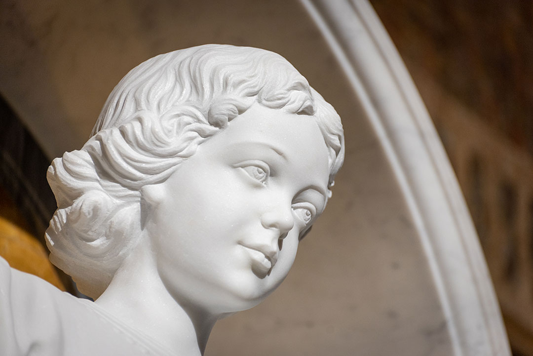 Installed marble sculpture of Venerable Cornelia Connelly with floral tribute by Rugo Stone – Specialists in Stone Carving & Church Installations