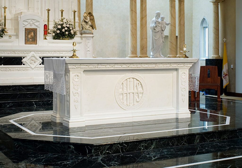 Elegant marble altar featuring intricate carvings and smooth finishes, showcasing masterful craftsmanship.